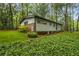 Backyard featuring lush greenery and tree coverage surrounding home at 2700 Brook Park Way, Doraville, GA 30340