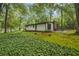 Backyard with grass, patio and mature trees surrounding home at 2700 Brook Park Way, Doraville, GA 30340