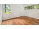 Empty bedroom featuring hardwood floors, natural light, and green scenery at 2700 Brook Park Way, Doraville, GA 30340