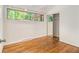 Bright bedroom with hardwood floors, closet, and large window overlooking wooded area at 2700 Brook Park Way, Doraville, GA 30340