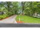 Long driveway leading to a home nestled among lush trees at 2700 Brook Park Way, Doraville, GA 30340