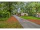 Long paved driveway leading to a home nestled among lush trees at 2700 Brook Park Way, Doraville, GA 30340