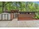Mid-century modern home with brick facade, shed, and mature trees at 2700 Brook Park Way, Doraville, GA 30340