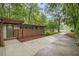 Home exterior with brick facade, long driveway, and tree coverage at 2700 Brook Park Way, Doraville, GA 30340