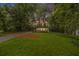 Charming home featuring a lush green lawn, mature trees, and inviting curb appeal at 2700 Brook Park Way, Doraville, GA 30340