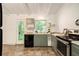 Cozy kitchen featuring garden view, stainless steel appliances, and gray cabinets at 2700 Brook Park Way, Doraville, GA 30340