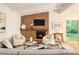 Cozy living room with brick fireplace, comfortable seating, and abundant natural light at 2700 Brook Park Way, Doraville, GA 30340