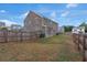 Wide view of backyard with wood fence and well maintained lawn at 436 Vermeer Ct, Locust Grove, GA 30248