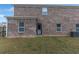 Brick exterior with a fenced backyard and an outdoor entry door at 436 Vermeer Ct, Locust Grove, GA 30248