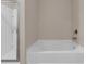 Bathroom featuring a pristine white tub and a sleek glass-enclosed shower for a modern, clean feel at 436 Vermeer Ct, Locust Grove, GA 30248