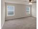 A bedroom offers neutral walls, a ceiling fan, and natural light at 436 Vermeer Ct, Locust Grove, GA 30248