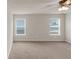A spacious bedroom with neutral walls offers a ceiling fan and natural light at 436 Vermeer Ct, Locust Grove, GA 30248