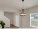 Open dining area featuring contemporary lighting, modern decor, neutral walls, and wood flooring at 436 Vermeer Ct, Locust Grove, GA 30248