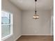 Bright dining area featuring wood floors, neutral walls, and a modern light fixture above at 436 Vermeer Ct, Locust Grove, GA 30248