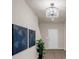 Inviting entryway featuring modern decor, a stylish chandelier, wood floors and a white front door at 436 Vermeer Ct, Locust Grove, GA 30248
