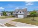 Two-story home with a brick and siding exterior, a spacious driveway, and a well-maintained lawn at 436 Vermeer Ct, Locust Grove, GA 30248