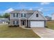 Attractive two-story house with a stone facade, a well-kept lawn, and an attached two-car garage at 436 Vermeer Ct, Locust Grove, GA 30248