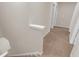 Hallway features a built-in display shelf and neutral carpet at 436 Vermeer Ct, Locust Grove, GA 30248