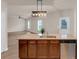 Open kitchen with granite counters, a stainless steel dishwasher, and views into the living area at 436 Vermeer Ct, Locust Grove, GA 30248