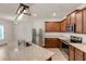 Open kitchen featuring stainless steel appliances, wooden cabinets, and granite countertops at 436 Vermeer Ct, Locust Grove, GA 30248