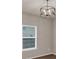 Bright dining area featuring a modern chandelier and a large window at 436 Vermeer Ct, Locust Grove, GA 30248