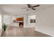 Open-concept living room with wood floors that flows into a modern kitchen at 436 Vermeer Ct, Locust Grove, GA 30248