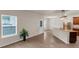 Bright living room featuring a large window, wood floors, and stainless steel appliances at 436 Vermeer Ct, Locust Grove, GA 30248