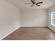 A bright living room shows modern floors and a ceiling fan at 436 Vermeer Ct, Locust Grove, GA 30248