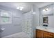 Bright bathroom with a shower, storage vanity, and a window for natural light at 5083 Lambeth Nw Ct, Acworth, GA 30101