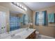 Bathroom featuring double sinks, a shower, and natural light from the window at 5083 Lambeth Nw Ct, Acworth, GA 30101