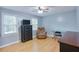 Bright bedroom with hardwood floors, natural light, dresser, and comfortable chair at 5083 Lambeth Nw Ct, Acworth, GA 30101