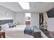 Cozy bedroom featuring a comfortable bed, adjacent bathroom, and convenient closet space at 5083 Lambeth Nw Ct, Acworth, GA 30101