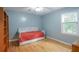 Comfortable bedroom featuring hardwood floors, a daybed, and natural light from the window at 5083 Lambeth Nw Ct, Acworth, GA 30101