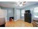 Cozy bedroom with hardwood floors, dresser, and a comfortable armchair at 5083 Lambeth Nw Ct, Acworth, GA 30101