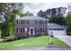 Charming two-story brick home with black shutters, a green lawn, and a two-car garage at 5083 Lambeth Nw Ct, Acworth, GA 30101