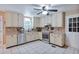 Bright kitchen with white cabinets, stainless steel appliances, and mosaic tile backsplash at 5083 Lambeth Nw Ct, Acworth, GA 30101