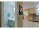 View of the kitchen showcasing cabinets, stainless appliances, and tiled flooring with a bathroom nearby at 5083 Lambeth Nw Ct, Acworth, GA 30101