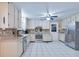 Spacious kitchen featuring white cabinets, stainless steel appliances, and tile flooring at 5083 Lambeth Nw Ct, Acworth, GA 30101
