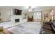 Spacious living room with hardwood floors, a large rug, a white brick fireplace and plenty of seating at 5083 Lambeth Nw Ct, Acworth, GA 30101