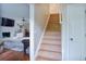 View of staircase and open-plan living room with fireplace, hardwood floors, and modern decor at 5083 Lambeth Nw Ct, Acworth, GA 30101
