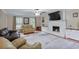 Large living room featuring hardwood floors, a white fireplace, and leather seating furniture at 5083 Lambeth Nw Ct, Acworth, GA 30101
