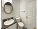 Bathroom features a toilet, sink, and ornate mirror at 5537 Panola Pl, Lithonia, GA 30058