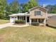 Charming two-story home with manicured lawn, and a driveway leading to a single-car garage at 5537 Panola Pl, Lithonia, GA 30058