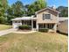 Charming two-story home with manicured lawn, and a driveway leading to a single-car garage at 5537 Panola Pl, Lithonia, GA 30058