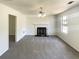 Clean, well-lit living room with a classic fireplace and neutral carpeting at 5537 Panola Pl, Lithonia, GA 30058