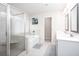 Well-lit bathroom featuring a bathtub, glass shower, and a double sink vanity at 637 Little Bear Loop, Canton, GA 30114