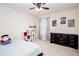 Cozy bedroom with cartoon artwork, ceiling fan, and neutral-toned walls and carpet at 637 Little Bear Loop, Canton, GA 30114