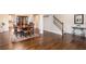 Open-concept dining room featuring hardwood floors, access to kitchen, and a staircase at 637 Little Bear Loop, Canton, GA 30114