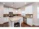 Gourmet kitchen featuring white cabinets, stainless steel appliances, and granite countertops with island seating at 637 Little Bear Loop, Canton, GA 30114