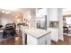 Open kitchen boasts a center island, stainless steel appliances, and seamless flow to dining spaces at 637 Little Bear Loop, Canton, GA 30114